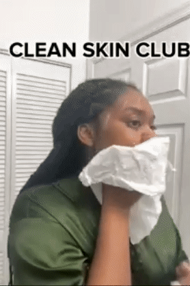 Reviewer using a white towel to clean their face 
