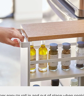 A close up of the pull handle and wooden top shelf