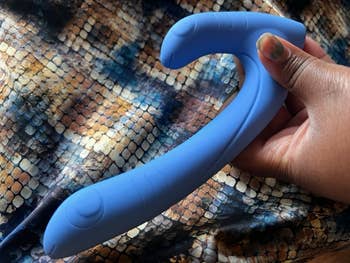Hand holding periwinkle sex toy