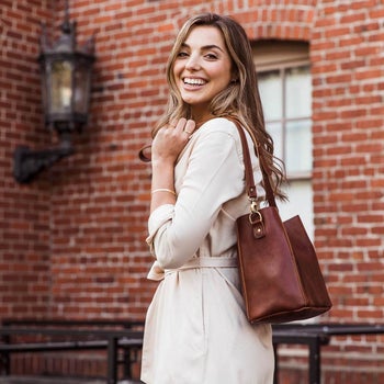 a model using a brown tote bag