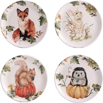 four plates where each has a different woodland creature. there is a fox, rabbit, squirrel, and hedgehog. 