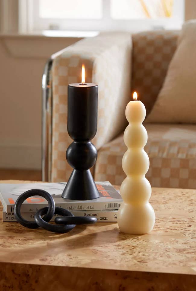 black and white pillar candles styled amongst other coffee table decor