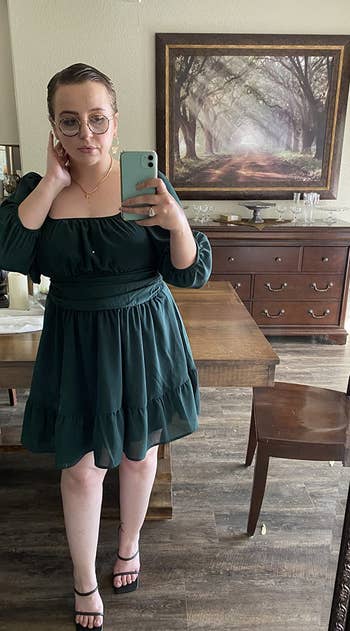image of reviewer wearing the dark green dress in a large