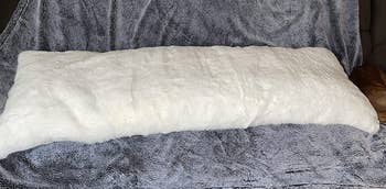 Reviewer image of the white faux fur pillow