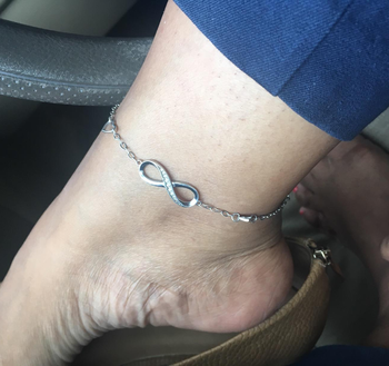 Reviewer wearing silver infinity anklet