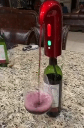 the device pouring red wine into a glass 