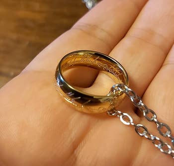 close up of the ring necklace in the palm of a reviewer's hand