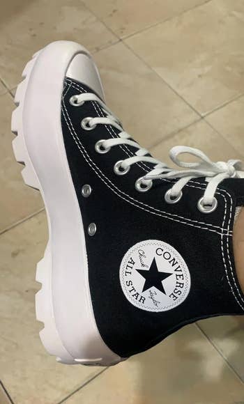 Reviewer wearing a classic high-top Converse sneaker with chunky sole