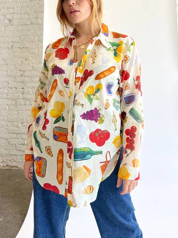Model wearing an oversized shirt with a bright food pattern