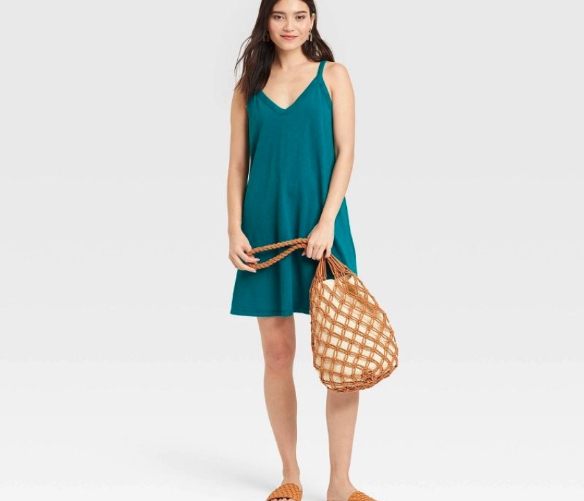 woman modeling a turquoise tank top dress