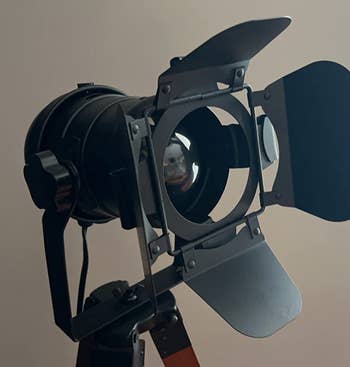 A studio spotlight on a stand, typical equipment for professional photography or filming