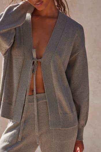 Person wearing a cozy knit cardigan and matching pants set, styled casually