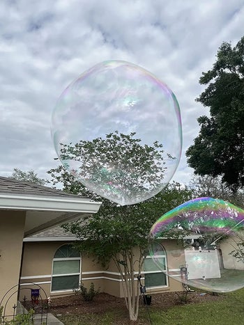 reviewer photo of two giant bubbles floating outside