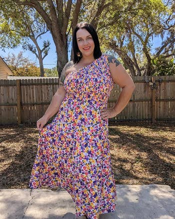 image of a reviewer wearing the floral white and purple one-shoulder dress