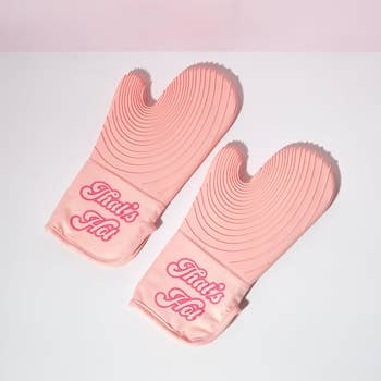 Two pinkish  oven mitts with the operation   