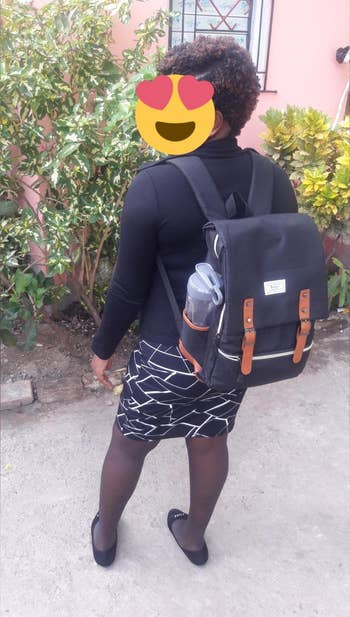 reviewer wearing the black backpack