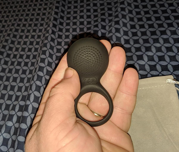 reviewer holding cock ring in hand