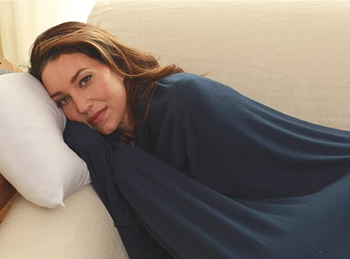 a model using the navy scarf as a blanket