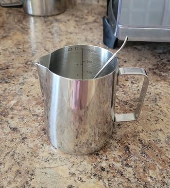 Reviewer photo of the milk frothing pitcher on kitchen counter
