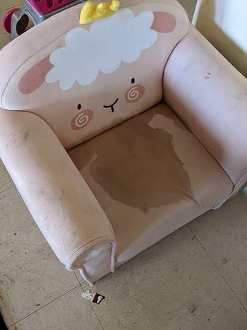 before photo of a dark stain on a light pink children's chair