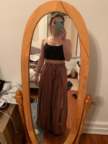 reviewer mirror selfie wearing black bralette and red and gray striped palazzo pants