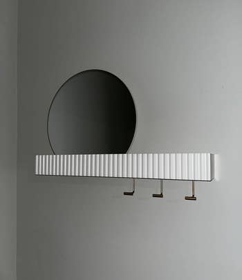 reviewer image of the mirror and shelf mounted on a wall