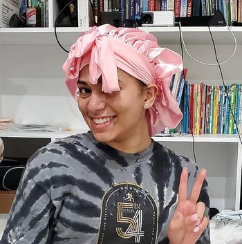 reviewer posing wearing bonnet successful pink