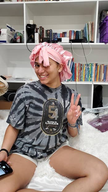 reviewer posing wearing bonnet in pink