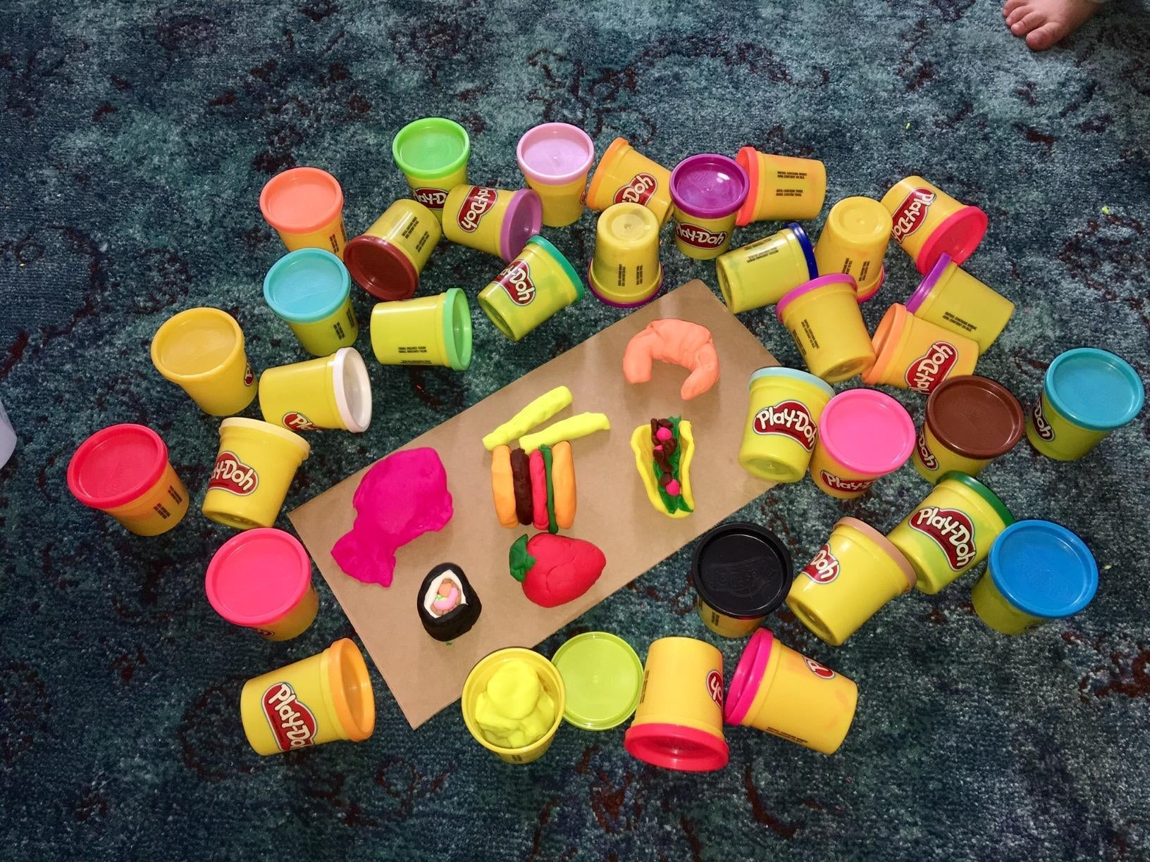 reviewer image of the 36 play-doh cans and several food items shaped out of play-doh