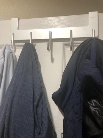 another reviewer photo of clothes hanging on the hook rack