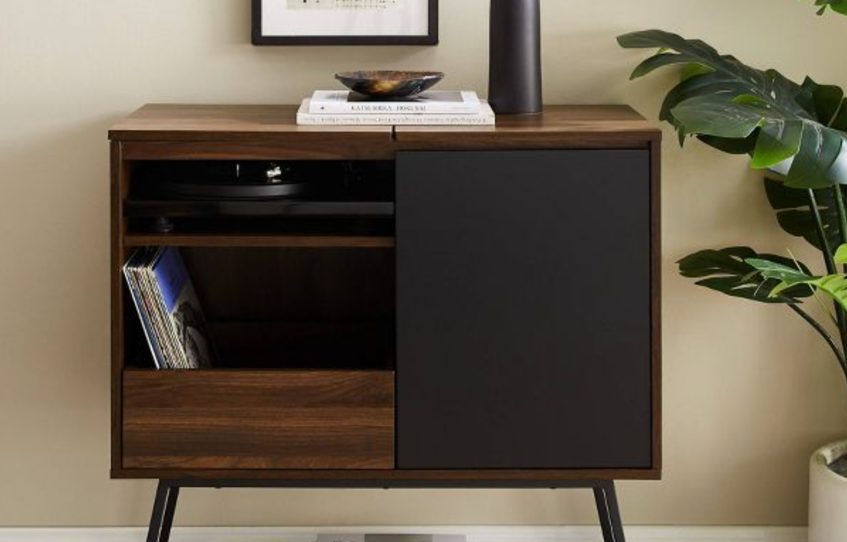 a black and brown media cabinet holding records and a record player