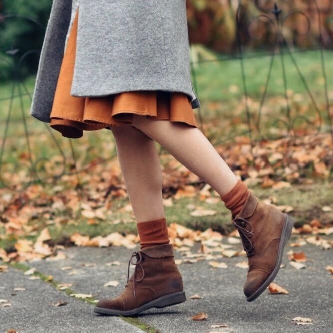 Reviewer photo of a person wearing orange socks under their tan boots
