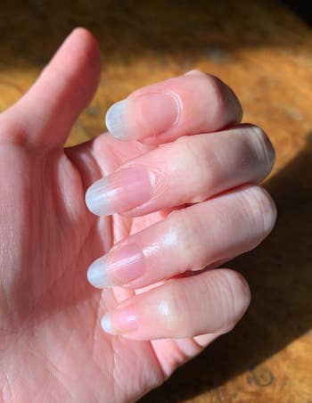 A reviewer's healthy-looking nails and cuticles after using the cuticle oil