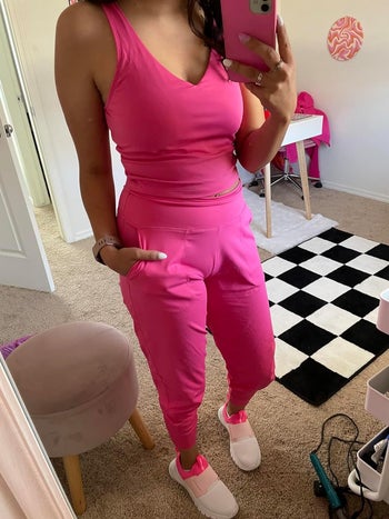 a reviewer in pink jogger pants