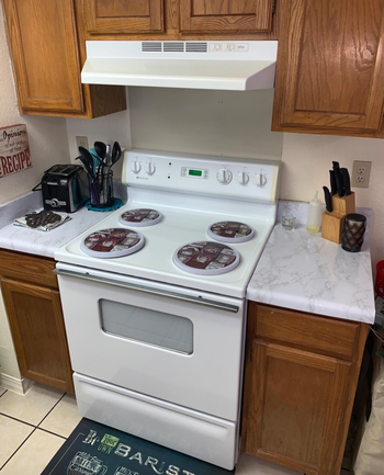 Reviewer image of white marble adhesive on kitchen counters 
