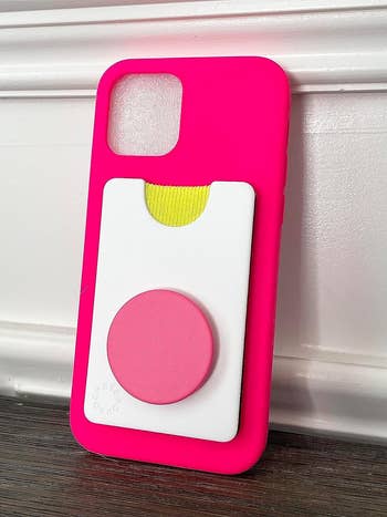 reviewer's phone case with white and pink popsocket wallet