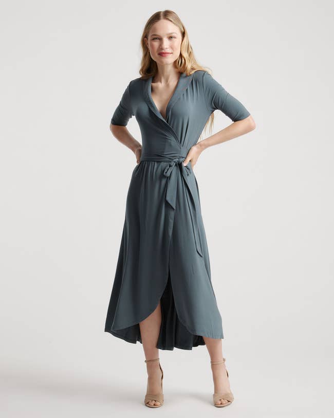 a model wearing a. midi wrap dress in dusty blue 