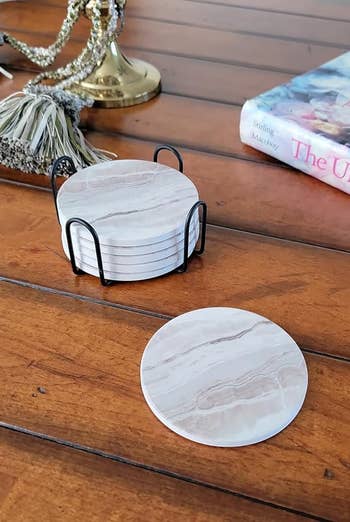 a reviewer shows the six marble coasters