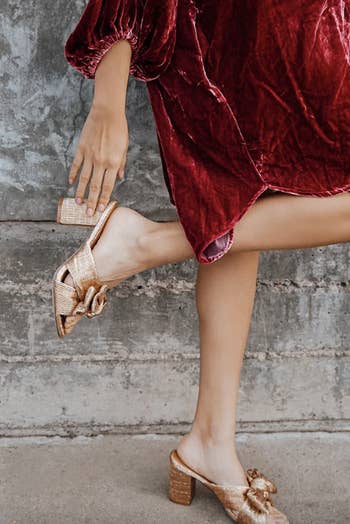 model in gold mules with low block heel