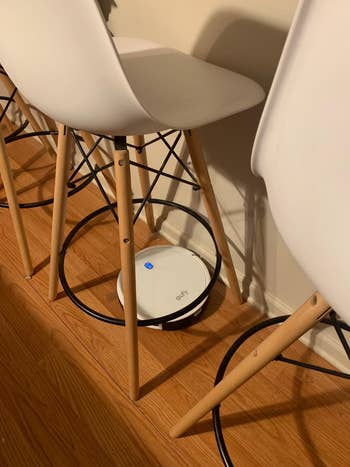 a reviewer's robot vacuum going under barstools
