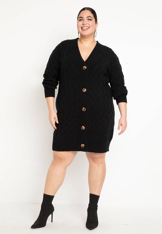 model posing in black sweater with black heels