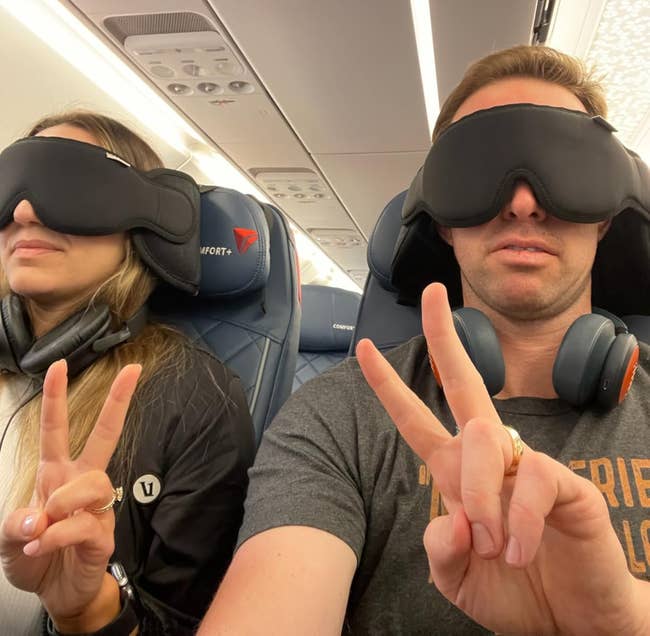 Two individuals connected an airplane wearing oculus masks and headphones flash bid signs, seated comfortably. Suitable for a buying nonfiction connected question accessories