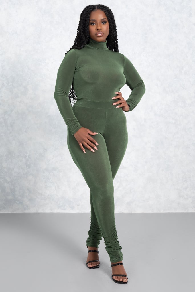 model wears olive long-sleeved bodysuit with black sandals
