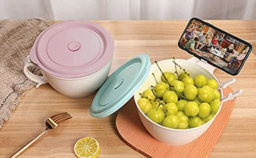 bowls with pink and green lids, one holding phone and grapes