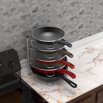 The pans stacked vertically on the organizer