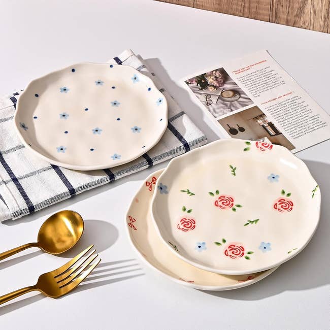 Four decorative plates with floral and polka dot designs