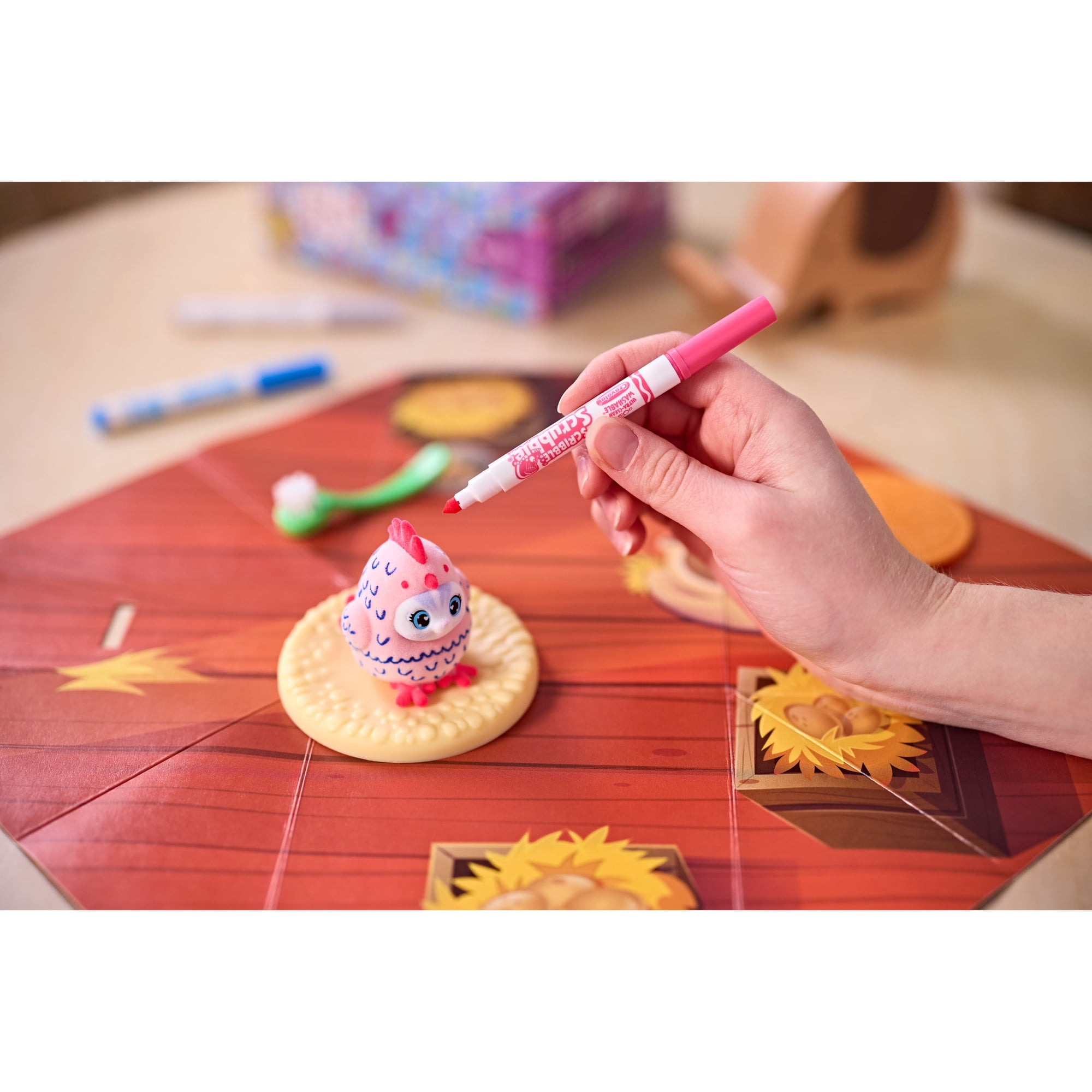Person decorates a pinkish  collectible artifact  with a reddish  marker connected  a colorful committee  crippled  mat featuring patterns