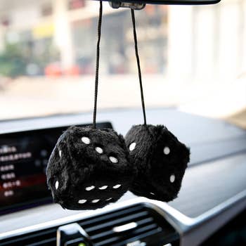 black fuzzy dice hanging in a car
