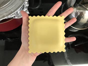 reviewer holding the ravioli-shaped rest in their hand, showing it's just a bit bigger than their palm