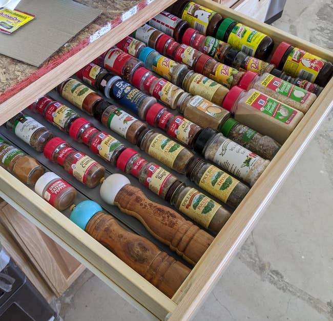 reviewer photo of spices neatly organized in a drawer with the liner